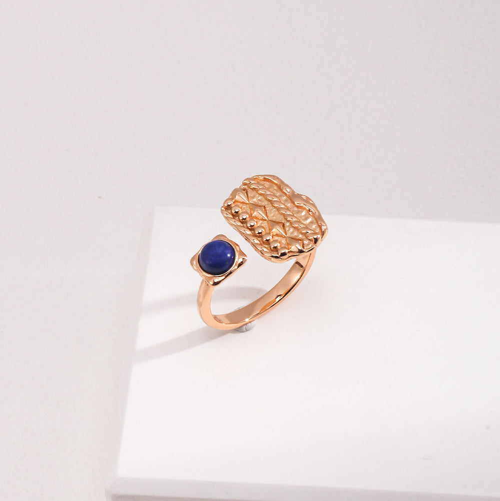gold ring with a blue Lapis Lazuli gemstone on a white box