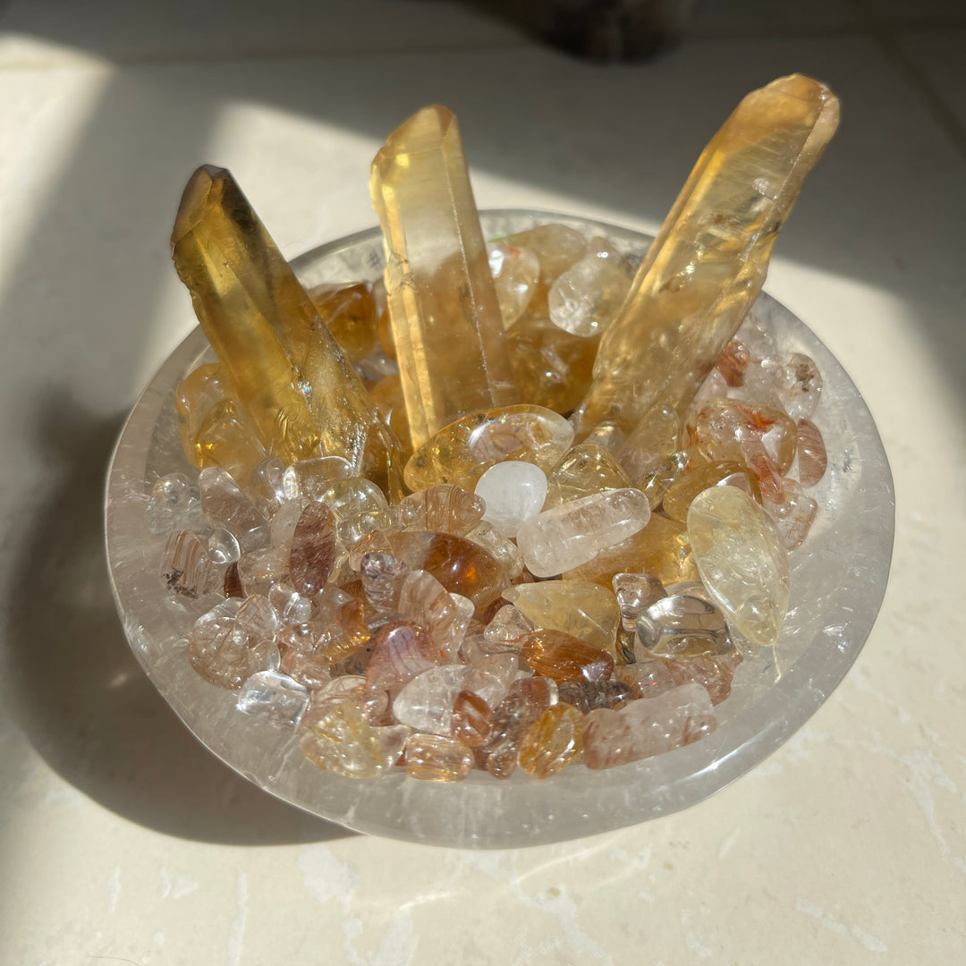 Abundance Bowl with natural Zambian Citrine, rutilated quartz chips and miniature Chinese Yuan Bao in a clear quartz bowl.
