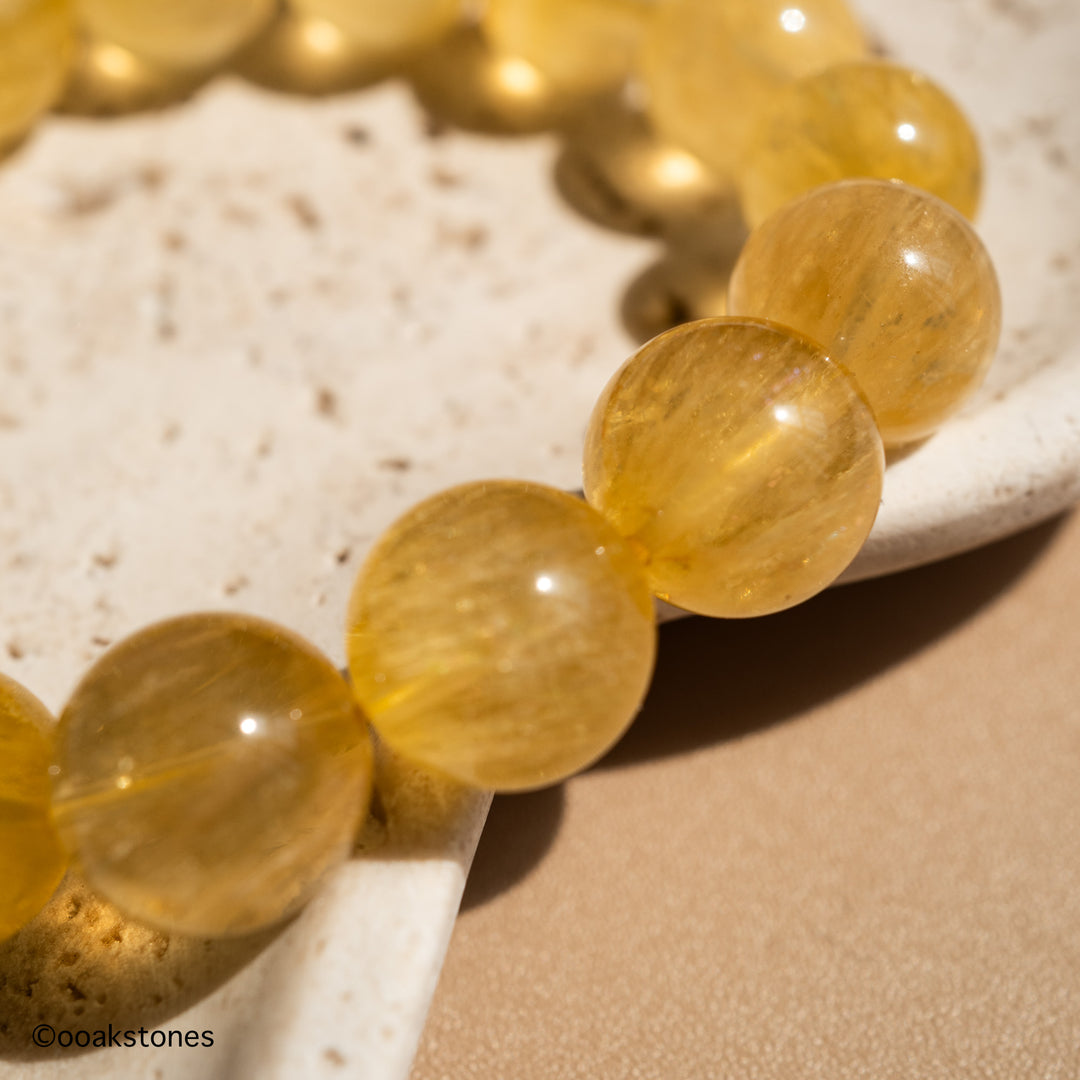 Close-up of natural Yellow Fluorite beads showing exceptional clarity, warm honey-yellow colour and beautiful internal glow.