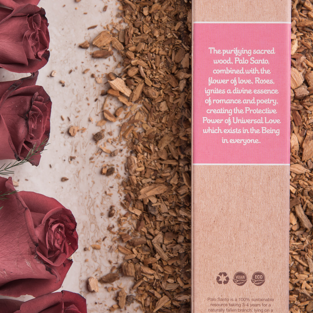 Palo Santo and red roses with a product description on a pink label.