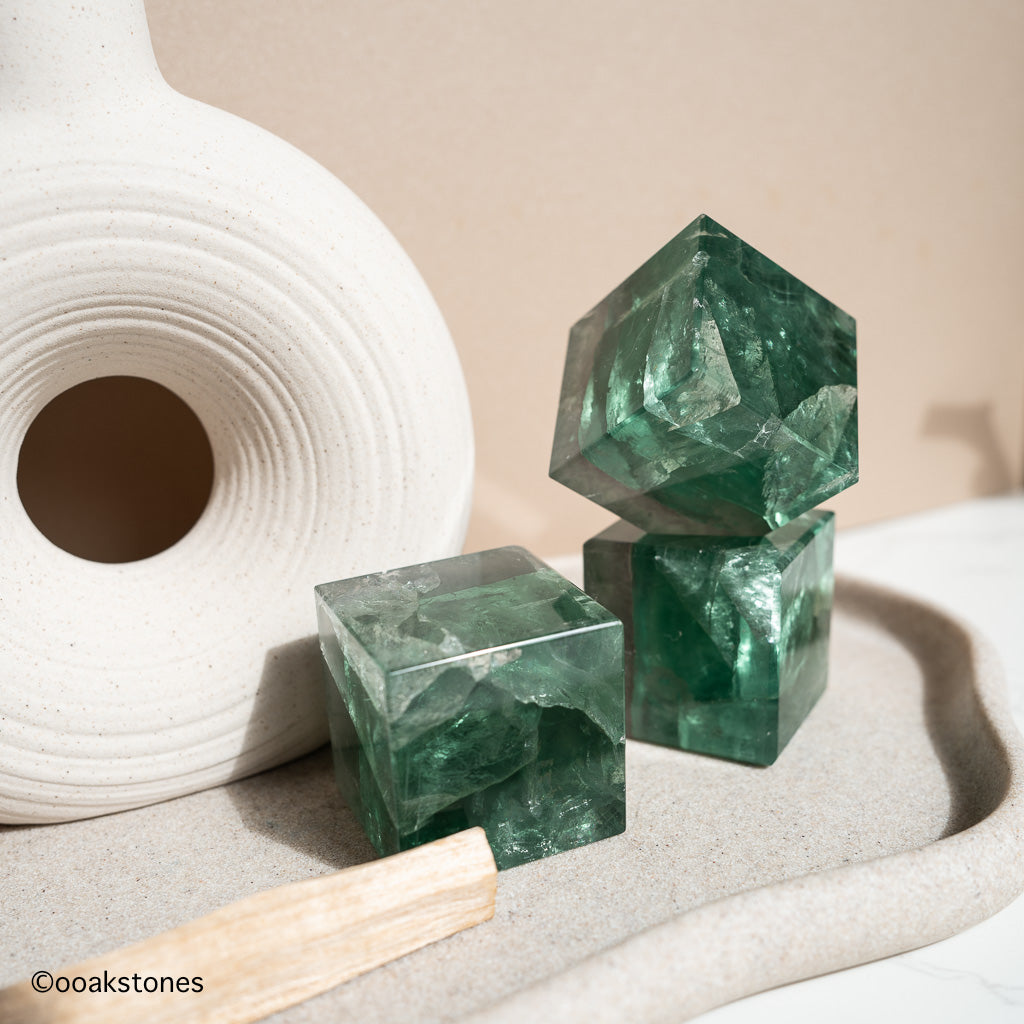 Green Fluorite cube crystal with natural sea-green tones, polished geometric form symbolizing clarity, balance, and structured energy