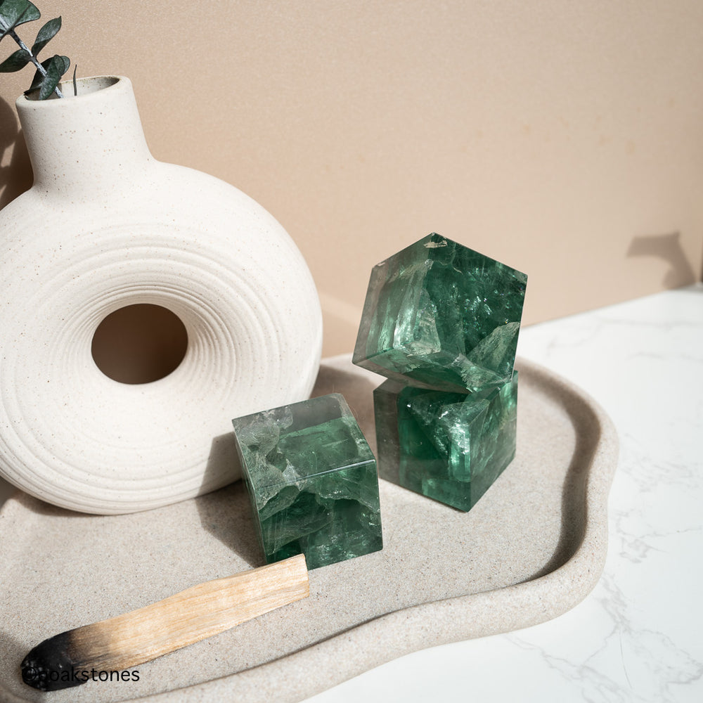 Green Fluorite cube crystal with natural sea-green tones, polished geometric form symbolizing clarity, balance, and structured energy