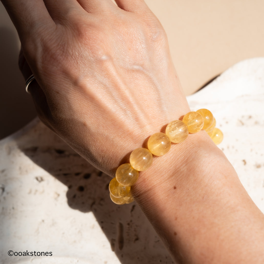 Yellow Fluorite crystal bracelet worn on the wrist, showcasing translucent golden beads and elegant everyday styling.
