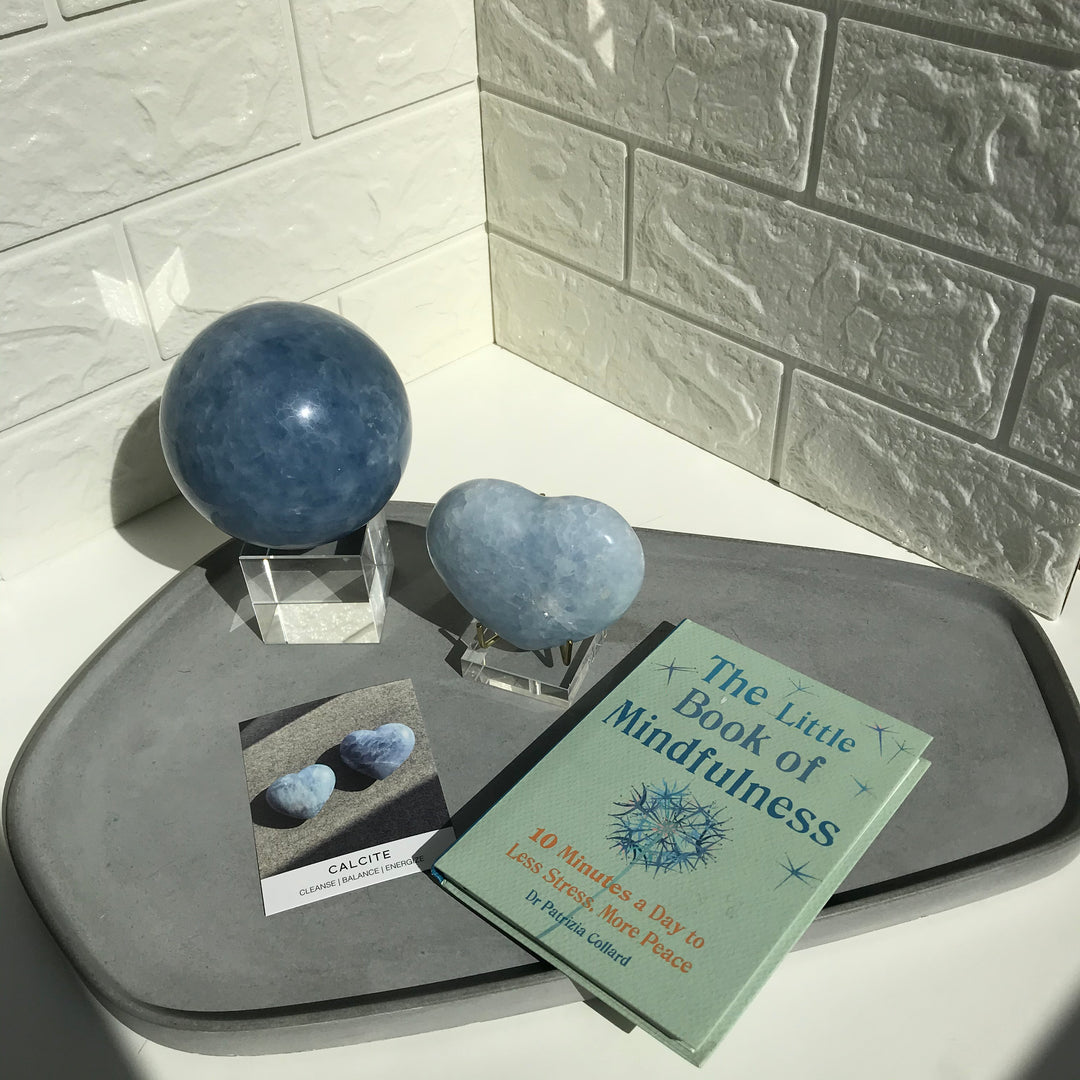 Natural blue calcite sphere from Madagascar with soft blue and white patterning