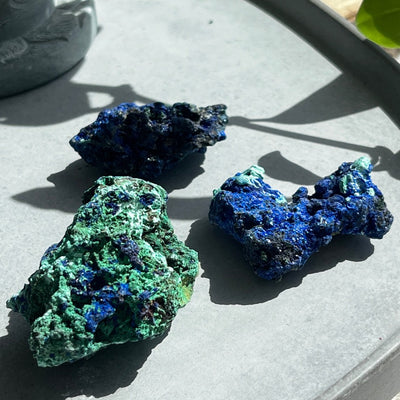 3 small azurite with malachite on display 