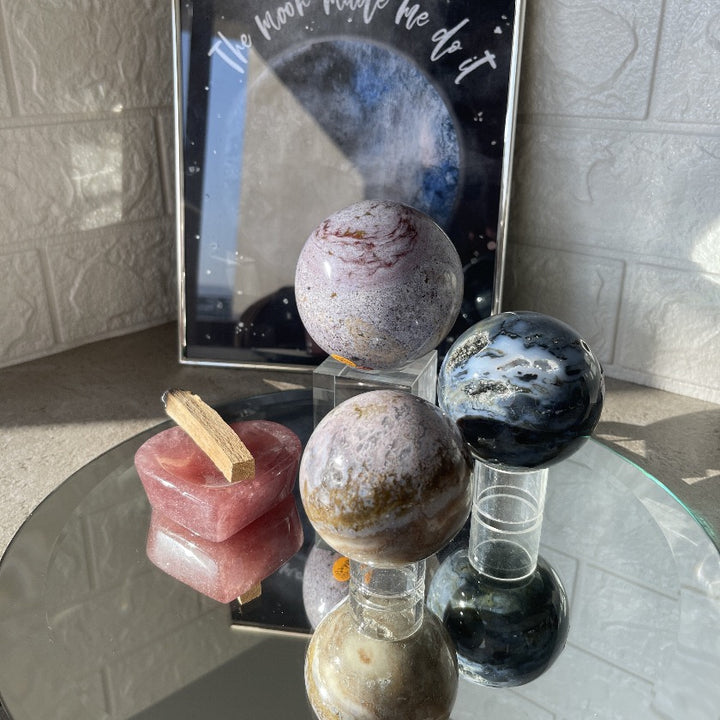 Ocean Jasper spheres in different color displayed on mirror plate