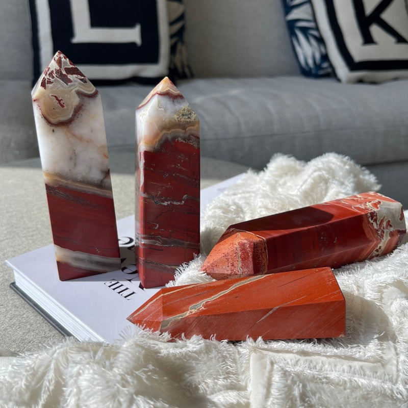 Red Jasper crystal displayed on book and fabrics