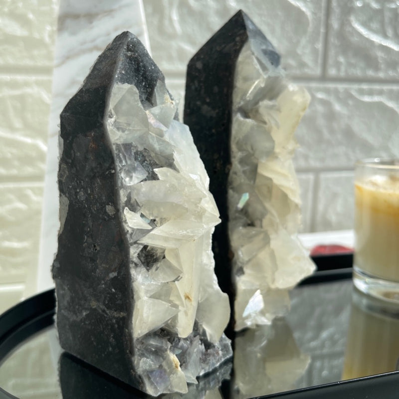 2 calcite tower places on mirror plate styled with a candle