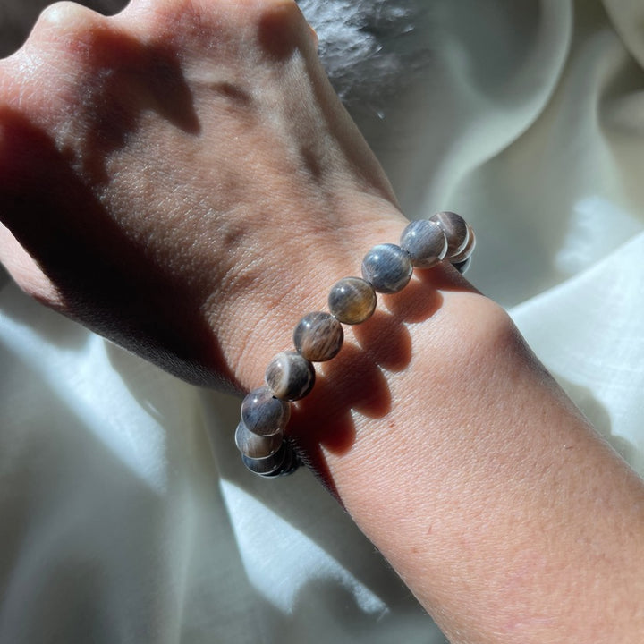 Model wearing black moonstone bracelet with silver sheen