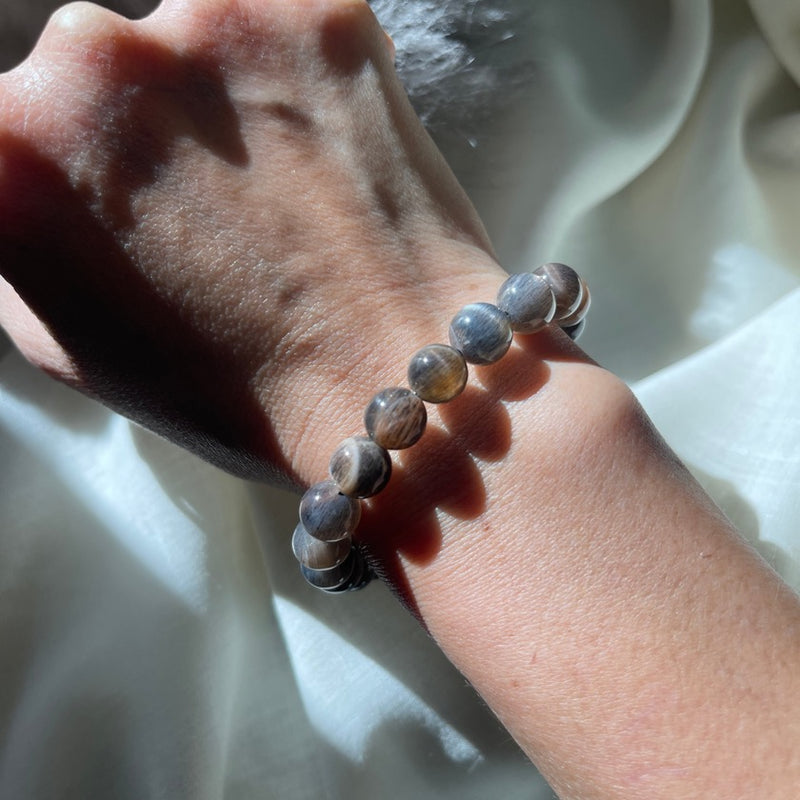 Model wearing black moonstone bracelet with silver sheen