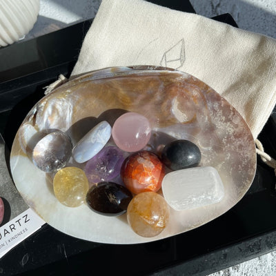 Colorful tumbled stones display on pearl shell