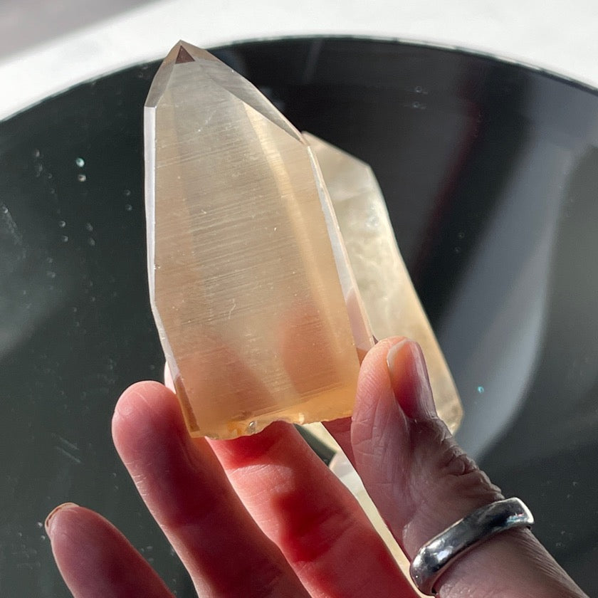 Champagne yellow citrine lemurian held in hand